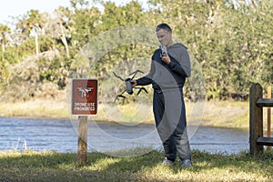 Operator is disappointed because he can not fly his quadcopter in national park no drone area. Man is unable to use his