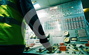 Operator hand on the control panel power plant