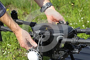 Operator hands adjusting quadcopter for launching it