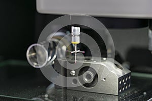 Operator inspection high precision part by CMM coordinate measuring machine photo