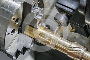 Operator machining automotive part by cnc turning machine,