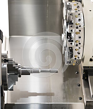 Operator machining automotive part by cnc turning machine