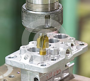 Operator machining automotive parts by machining center