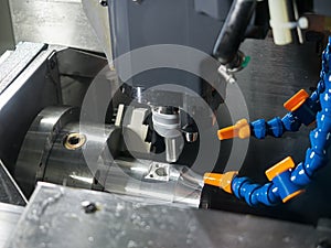 Operator machining precision part by CNC machining center 5 axis