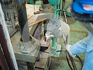 Operator pouring aluminum molten in to high precision casting mo