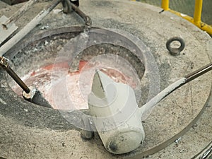 Operator pouring aluminum molten in to high precision casting mo