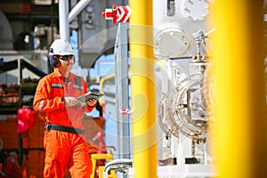 Operator recording operation of oil and gas process at oil and rig plant, offshore oil and gas industry, offshore oil and rig