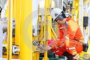 Operator recording operation of oil and gas process at oil and rig plant, offshore oil and gas industry, offshore oil and rig