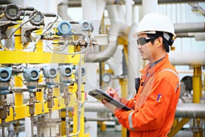 Operator recording operation of oil and gas process at oil and rig plant, offshore oil and gas industry, offshore oil and rig