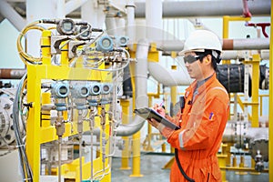 Operator recording operation of oil and gas process at oil and rig plant, offshore oil and gas industry, offshore oil and rig