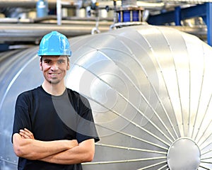 Operator repairs a machine in an industrial plant with tools