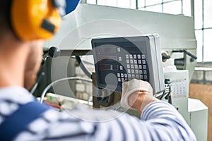 Operator Setting Up Machine at factory