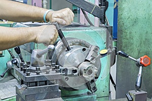 Operator setup turning part on manual lathe machine