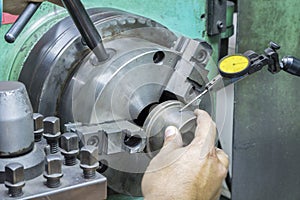 Operator setup turning part on manual lathe machine