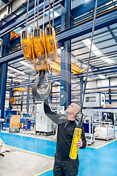 Operator using an industrial crane in a logistics factory