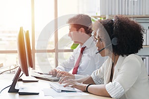 Operator woman agent with headsets working in a call centre