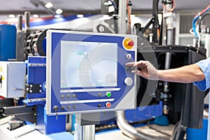 Operator working at programmable CNC machine