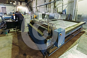 Operator works with plasma cutting machine with program control