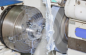 Operators grinding mold and die part by universal grining machine