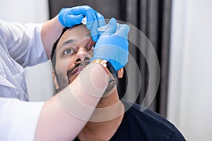 Ophtalmologist dropping eye drops to patients eyes