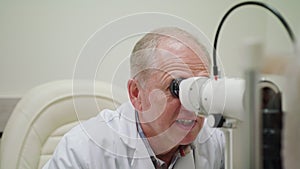 Ophtalmologist Examines and Talkes to the Patient photo