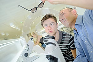 Ophtalmologist looking on pair glasses