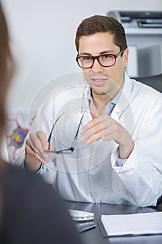 Ophtalmologist prescripting new glasses to patient with eyesight disease photo