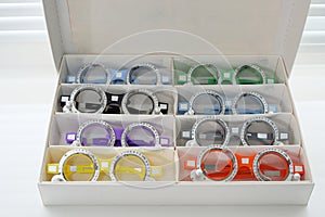 Ophthalmic glasses with lenses are folded into the cells of the case