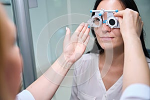 Ophthalmic professional performing monocular subjective refraction on patient