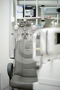 Ophthalmological cabinet with modern equipment in a medical clinic featuring an examination chair and phoropter, ready