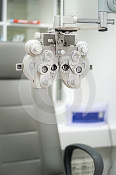 Ophthalmological cabinet with modern equipment in a medical clinic featuring an examination chair and phoropter, ready