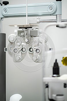 Ophthalmological cabinet with modern equipment in a medical clinic featuring an examination chair and phoropter, ready