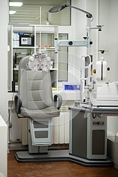 Ophthalmological cabinet with modern equipment in a medical clinic featuring an examination chair and phoropter, ready