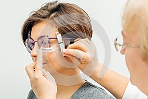 Ophthalmologist is checking up patient in eye doctor hospital