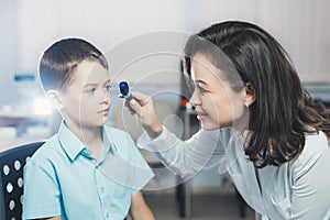 Ophthalmologist checks the boy`s vision. Vision tests in children. Hyperopia