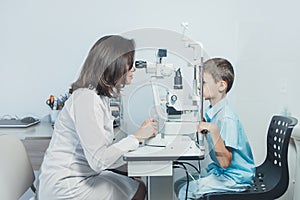 Ophthalmologist checks the boy`s vision. Vision tests in children. Hyperopia