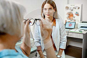 Ophthalmologist consulting senior woman in the office