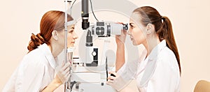 Ophthalmologist doctor in exam optician laboratory with female patient. Eye care