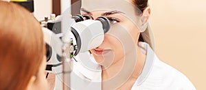 Ophthalmologist doctor in exam optician laboratory with female patient. Eye care medical diagnostic. Eyelid treatment