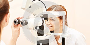 Ophthalmologist doctor in exam optician laboratory with female patient. Eye care medical diagnostic. Eyelid treatment