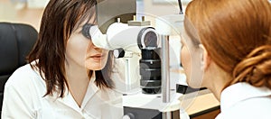 Ophthalmologist doctor in exam optician laboratory with female patient. Eye care medical diagnostic. Eyelid treatment