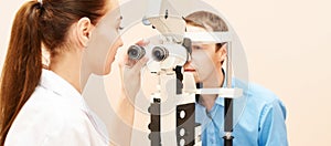 Ophthalmologist doctor in exam optician laboratory with male patient. Men eye care medical diagnostic. Eyelid treatment