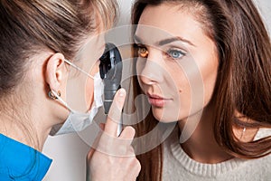 Ophthalmologist examines the eyes using a ophthalmic device photo