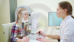 ophthalmologist examines the girl on a corneo topographer. modern clinic.