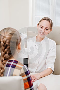 ophthalmologist examines the girl on a corneo topographer. modern clinic.