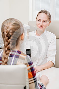 ophthalmologist examines the girl on a corneo topographer. modern clinic.