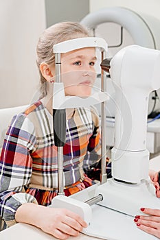 ophthalmologist examines the girl on a corneo topographer. modern clinic.