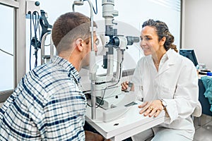 Ophthalmologist examining a man's eyes with a slit lamp