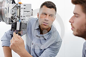ophthalmologist examining young man with optometric machine