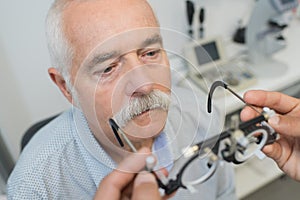 Ophthalmologist holding eyeglasses for try out